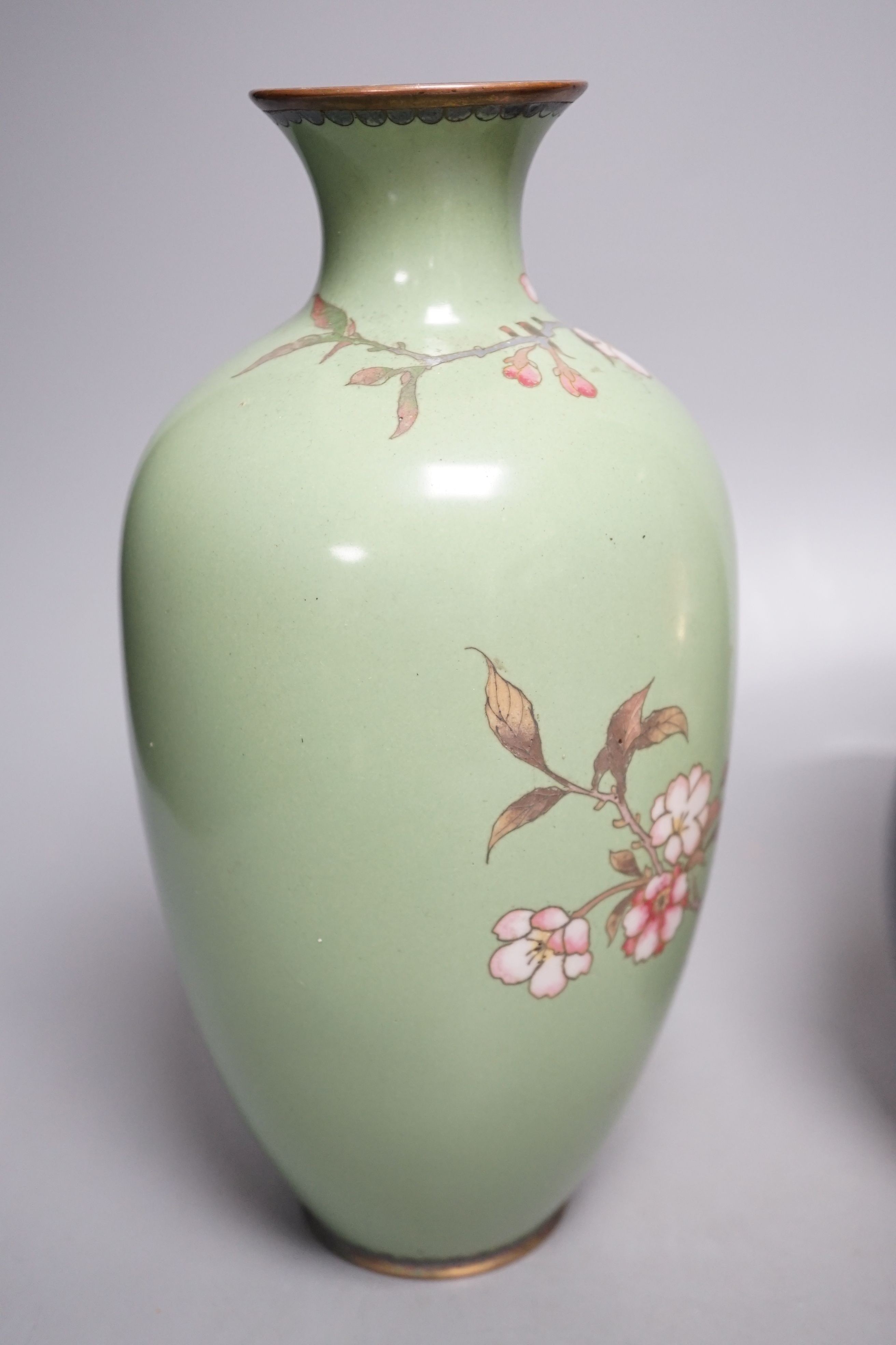 A Japanese cloisonné enamel vase and a Japanese mixed metal vase, cloisonné vase 25 cms high.